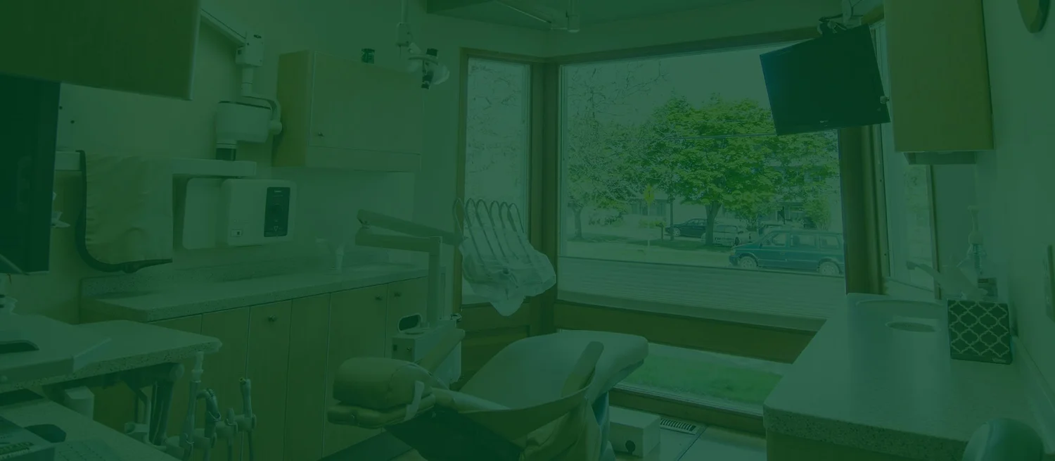 A treatment room with a ceiling-mounted screen